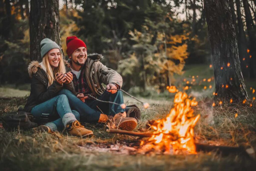 Traveler couple camping and roasting marshmallows