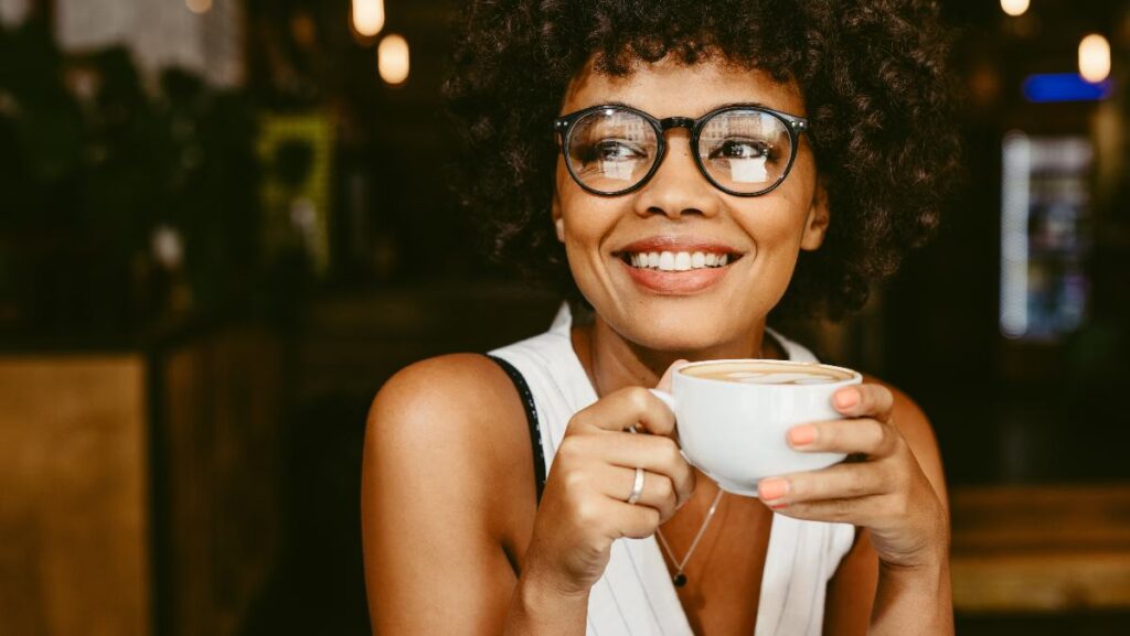 A woman at a cafe having coffee
