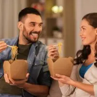 Couple eating takeout food