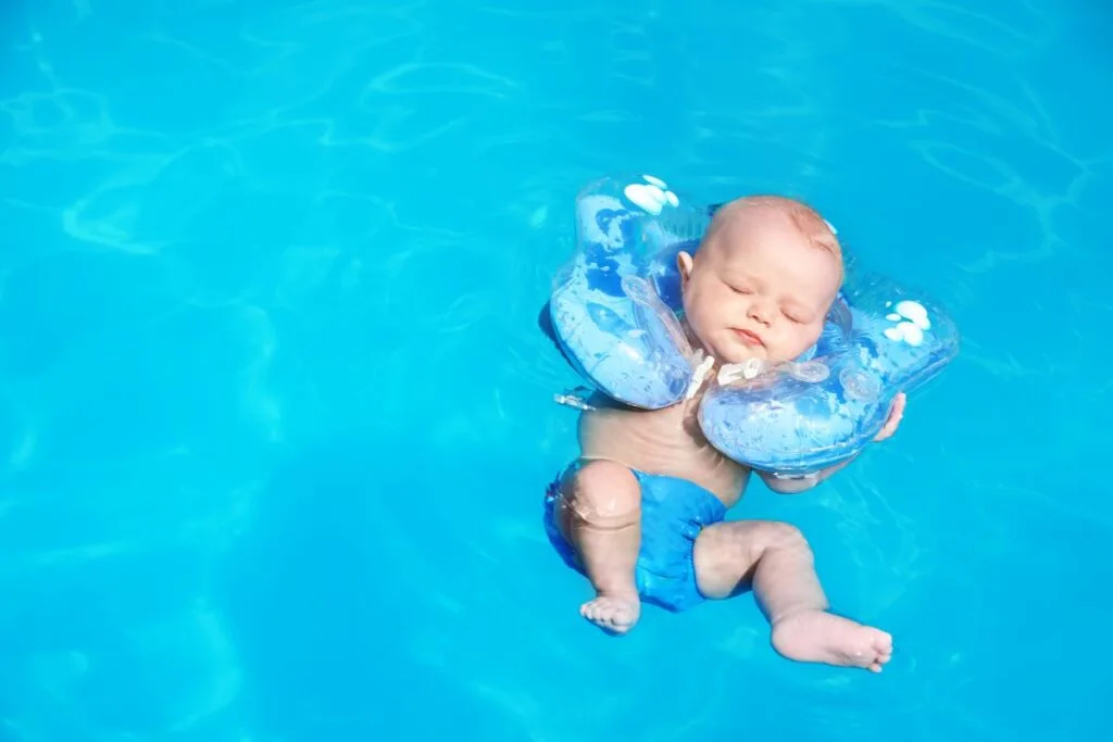 Baby floating in a pool.