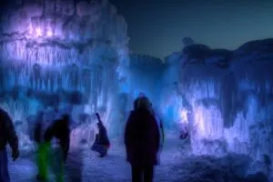 Silhouettes in front of purple and blue ice castles.