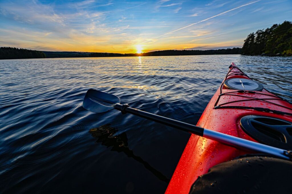 A kayak on a lake at sunset.