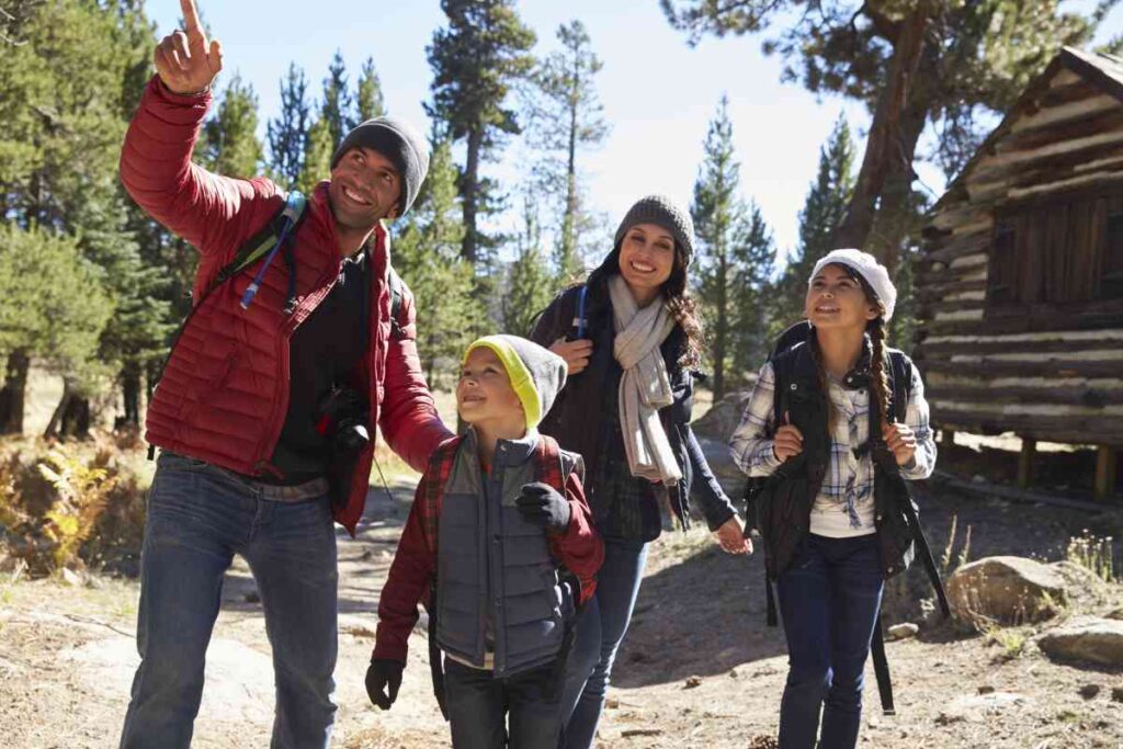 Family Exploring Around a Cabin