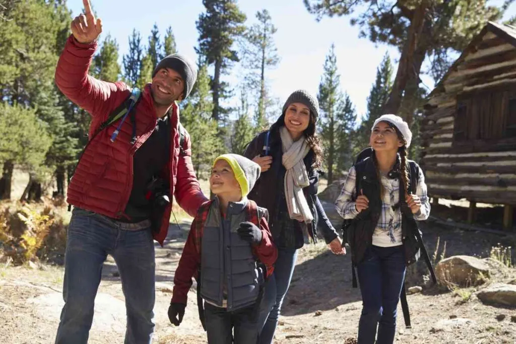 Family Exploring Around a Cabin