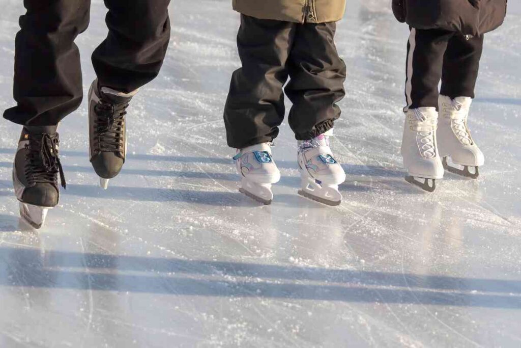 Three ice skater on a frozen lake.