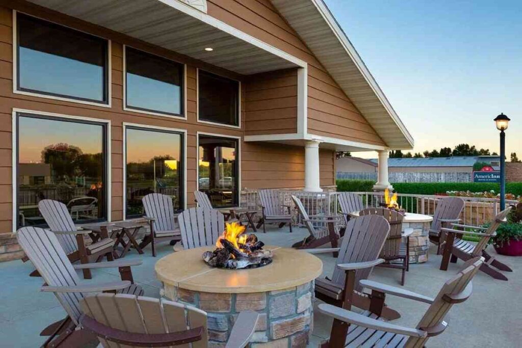 Tables and chairs on a deck with tabletop firepits