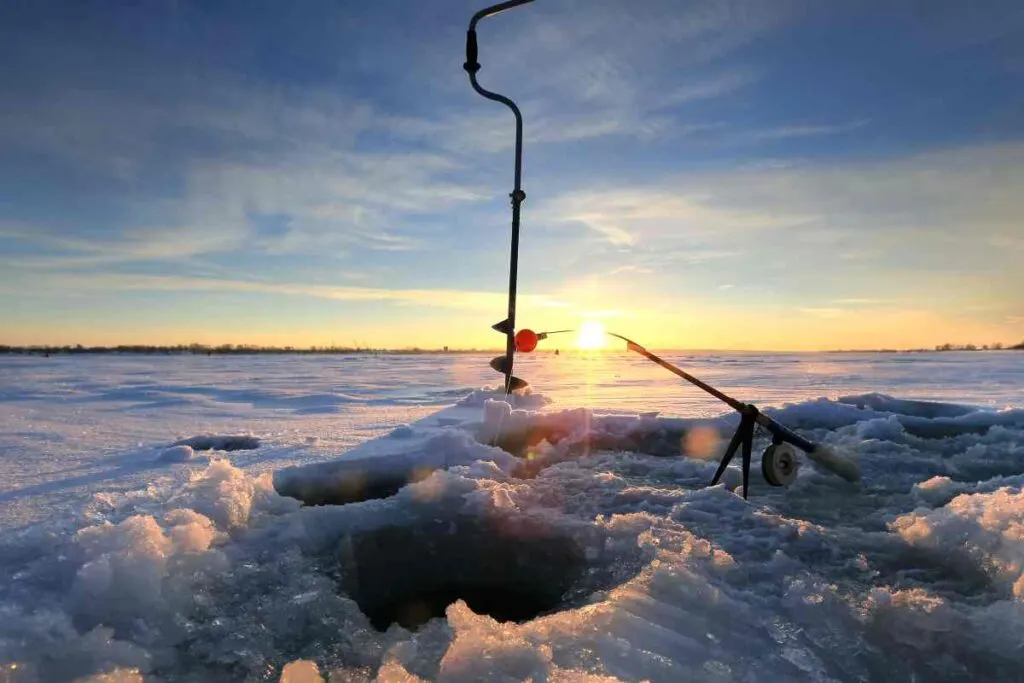 Ice fishing with a drill and ice fishing pole