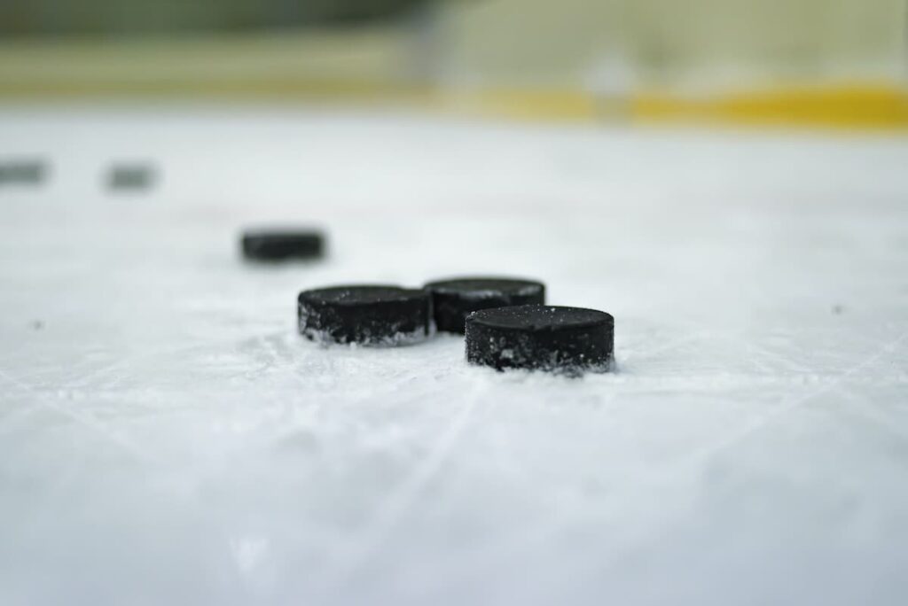 Hockey pucks on the ice.