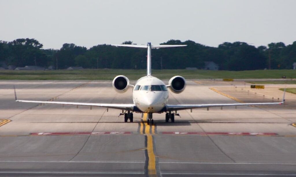 A passenger jet on the runway of an airport.