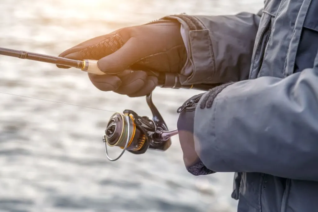 Fishing on the lake at sunset, probably using the best fishing line for bass.