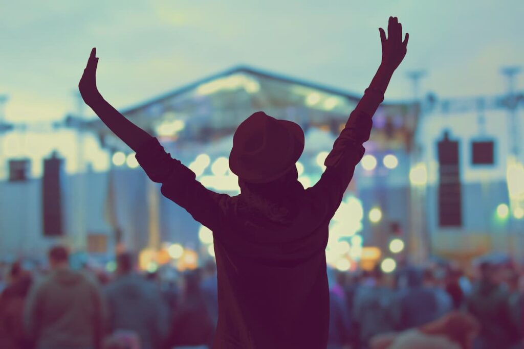 Girl at a music festival near sunset.