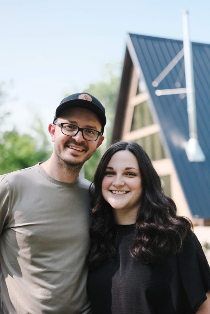 Tyler and Mary in front of the A Frame Cabin.