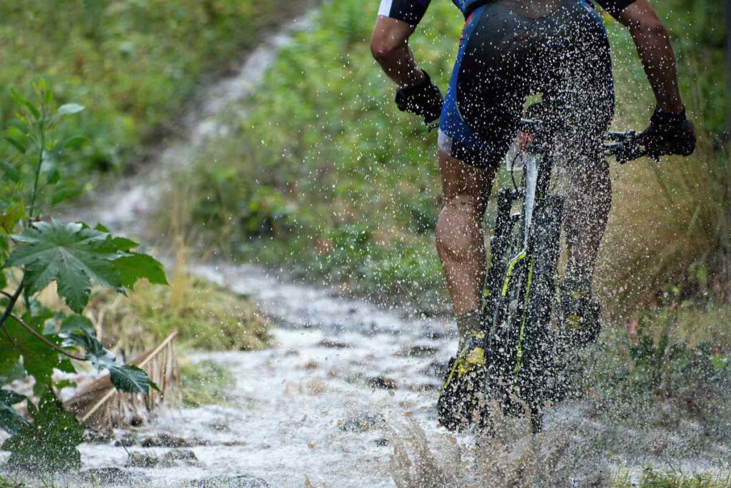 Man riding the best mountain bike through a stream