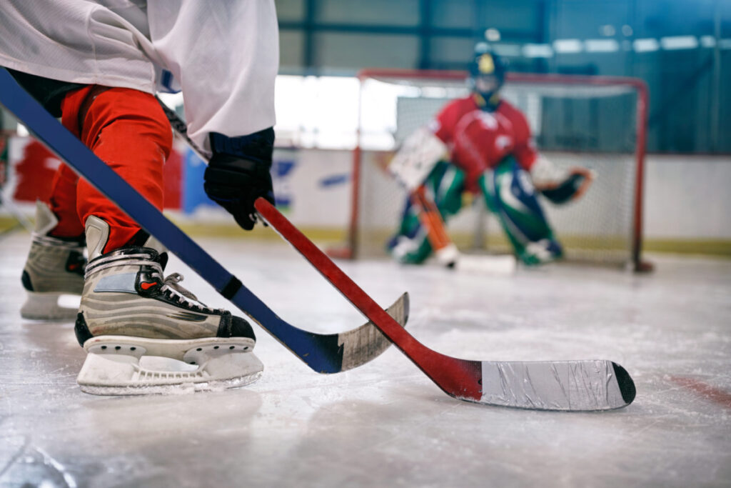 ice hockey player in action kicking with stick