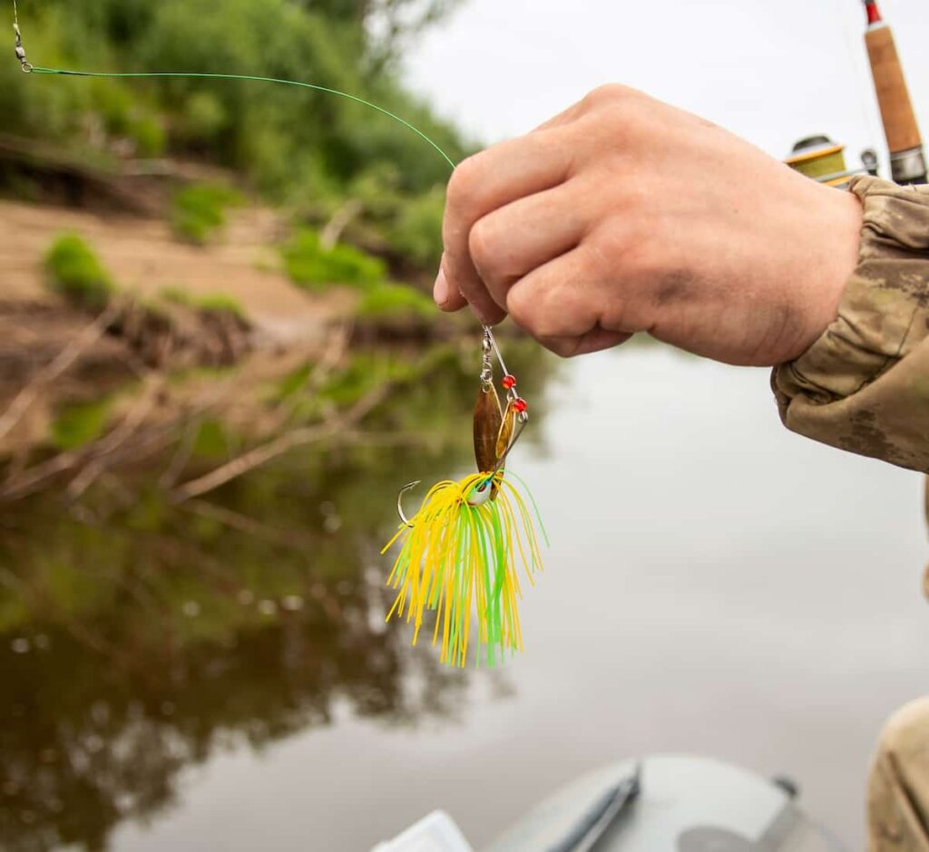 Man holding a spinnerbait fishing lure.