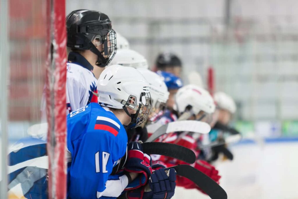 A group of youth hockey players waiting to get on the ice.